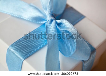 White box with blue tape
