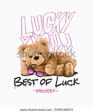 best of luck slogan with bear doll holding sunglasses lying on floor vector illustration 商業照片 © 
