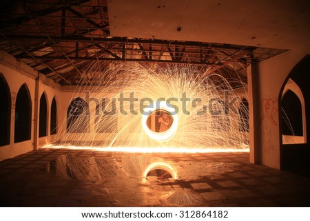 A circle of light dancing in an abandoned building - Steel wool