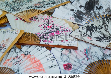 BANGKOK, THAILNAD - FEBRUARY 15: Painted on Chinese paper fan on sale at Central World Plaza during the Chinese New Year celebrations on February 15, 2015 in Bangkok, Thailand