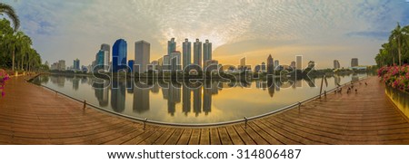 BANGKOK, THAILAND - 13 APRIL 2015 : Landscape panorama skyscraper business district at dawn sky, beautiful water reflection.