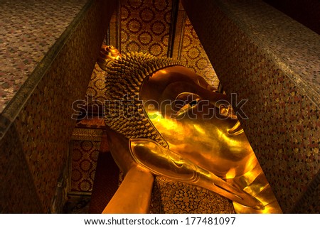Reclining Buddha gold statue face at Bangkok, Thailand