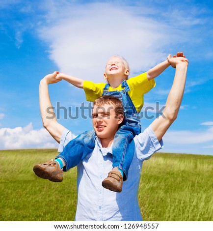 happy father and his son outdoor on a summer day