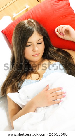 portrait of a beautiful young woman sleeping peacefully in her bed