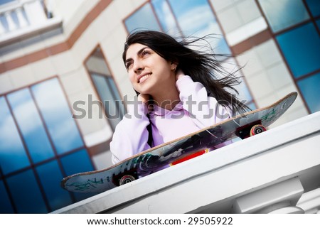 portrait of a pretty teenage girl with a skate board outdoor