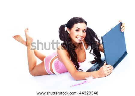 studio portrait of a sexy brunette girl sitting on the floor with a laptop