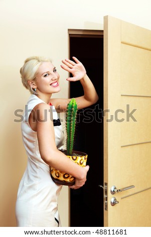 beautiful young businesswoman with a flower in her hands leaving the job