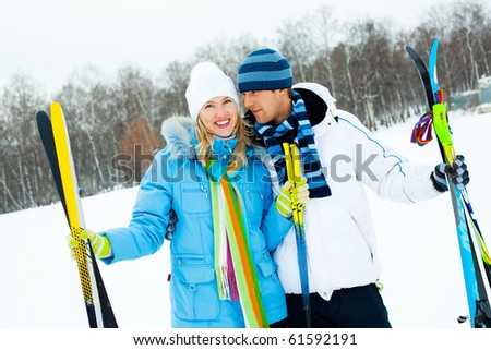 happy young couple going skiing on a warm winter day