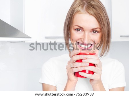 beautiful happy young woman drinking coffee at home in the morning