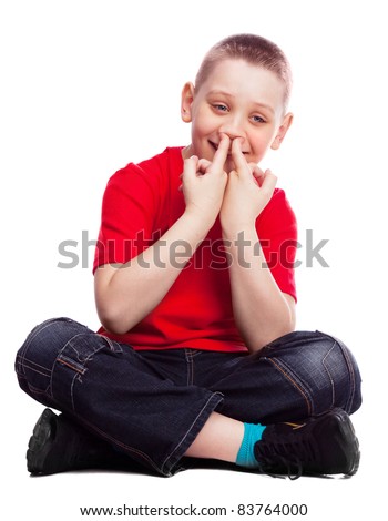 ten year old boy picking his nose , isolated against white background