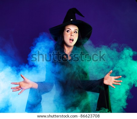 angry brunette witch saying the spell with clouds of smoke around her, isolated against white background