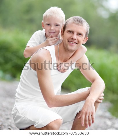 happy  family; young father and his five year old son spending time outdoor on a summer day (focus on the man)