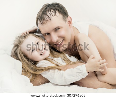 father and his five years old daughter, in bed at home