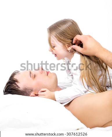 father and his five years old daughter, in bed at home