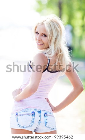 slim young woman wearing jeans shorts on a summer day