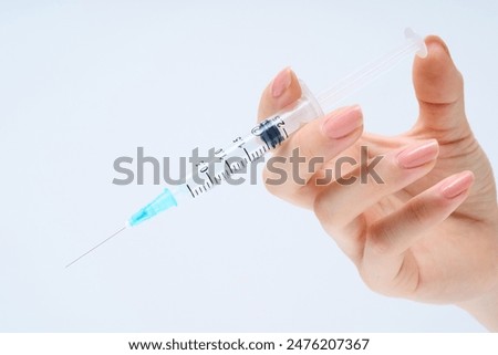 Similar – Image, Stock Photo Hand with syringe on red background with copy space