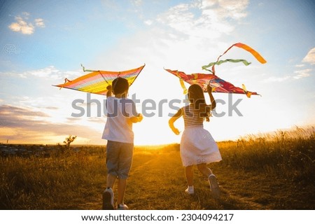 Similar – Image, Stock Photo Brother and sister playing on the field at the day time. Children having fun outdoors. They running on the lawn. Concept of friendly family.