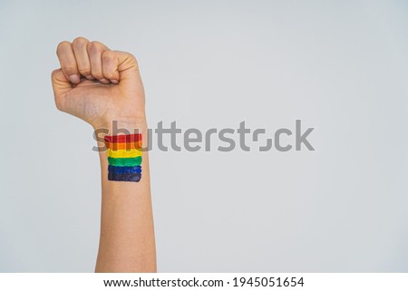 LGBT supporter, arm with lgbt rainbow painted on it, conceptual support for gay people, lesbians, transgender and against homophobia