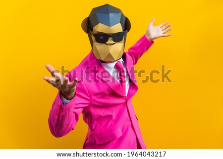 Happy man with funny low poly mask on colored background - Creative conceptual idea for advertising,adult with low-poly origami paper mask doing funny poses Foto stock © 
