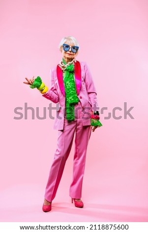 Happy and funny cool old lady with fashionable clothes portrait on colored background - Youthful grandmother with extravagant style, concepts about lifestyle, seniority and elderly people Foto stock © 