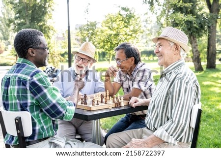 Group of senior friends playing chess game at the park. Lifestyle concepts about seniority and third age ストックフォト © 