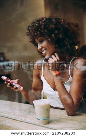 Beautful woman having a drink inside a cafe, view through the screen Photo stock © 