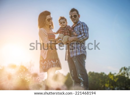 happy family with kid. Young parents holding their one year old son