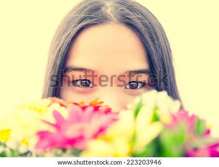 Asian girl portrait - Candid portrait of stunning beautiful asian woman smelling flowers