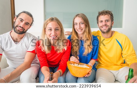 friends in front the television. football fans watching the match on tv