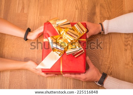 hands giving christmas present. original view to express a christmas concept