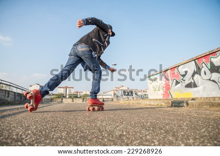 Cool man with roller skating shoes running - Concepts of youth,sport,lifestyle and 80s vintage style