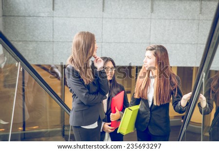three business women on the escalator going to work.