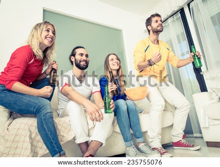 group of friends watching sport match on tv at home. concept about friendship and sport