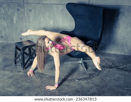 artistic gymnastic split on a chair. concept about art and fashion