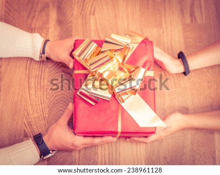 giving a present. two person sharing a present. concept about christmas and birthdays