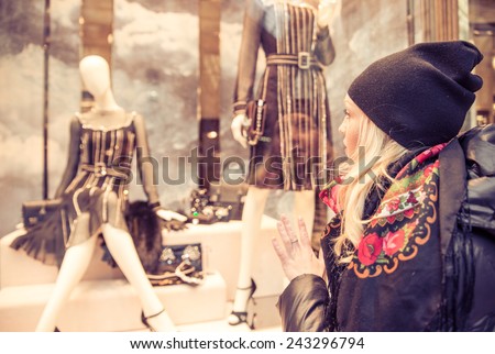 Pretty woman looking at window shop - Sale in clothes shop