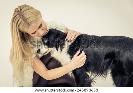 young girl hugging her border collie dog. concept about people and animals