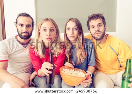 group of friends watching tv with a lot of interest. concept about sport, friendship, and home entertainment