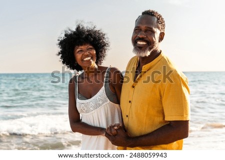 Image, Stock Photo Beautiful couple having fun in sunflowers field. A man and a woman in love walk in a field with sunflowers, a man hugs a woman. selective focus