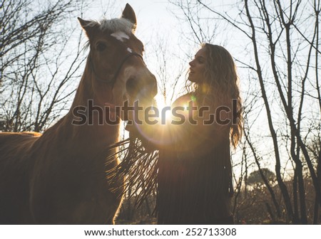 silhouette of a young woman with her horse. concept about animals and people
