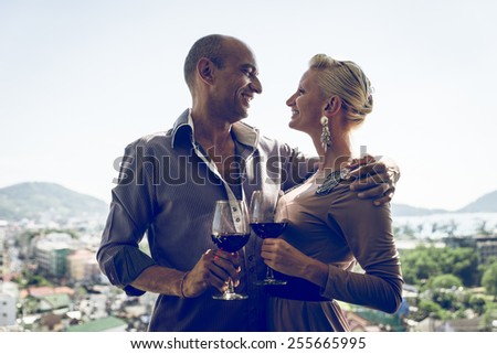 happy middle age couple having dinner in a restaurant and enjoying the view on the city