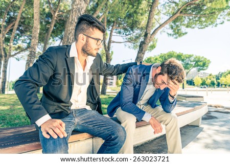 Young business man supporting a depressed person - Man supporting his friend despairing for his financial problems