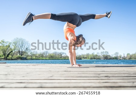 young woman training gymnastic in front of the lakes
