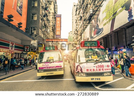 HONG KONG - FEBRUARY 12,2015: mini van buses in Mong Kok. Hong Kong is well known for the myriad of neon lights located above the roadways.