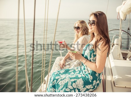 two friends on a cruise. young women on the sailing boat. concept about vacations, boat tours and people