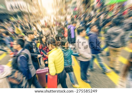 People crossing a streets - Crowd  in a city with radial blur - Concepts about traffic,urban life,shopping and lifestyle