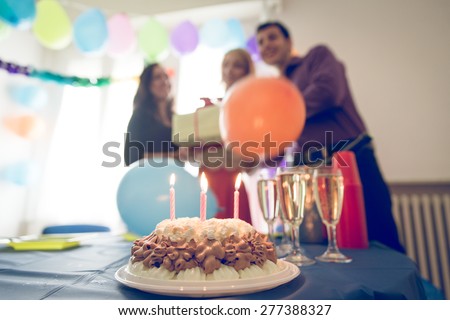 birthday party at home. three friends celebrating the girl birthday with surprise party at home. concept about birthday, party and people