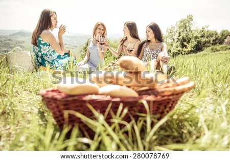 group of girls making picnic in the weekend on the hills. concept about food, friendship,nature and people