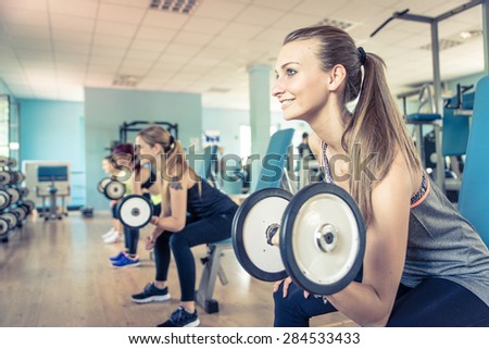 group of girls training in the gym with weights. concept about training and workout