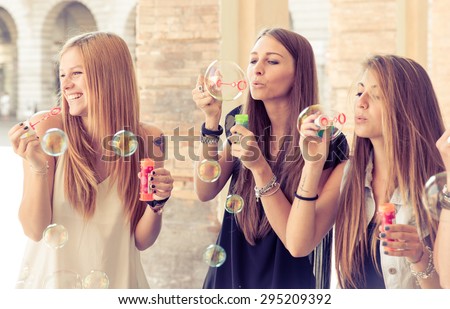 three young woman making soap bubble. concept about youth,women and carefree